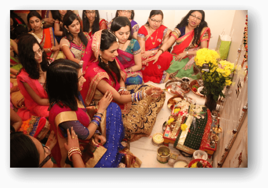 Girls offering aarti to Goddess Gauri