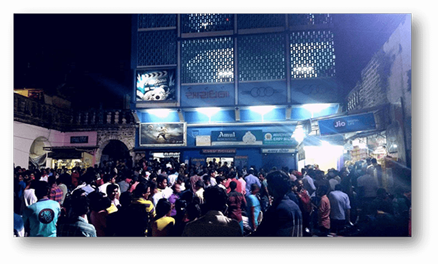 The crowd outside of the cinema during an evening session