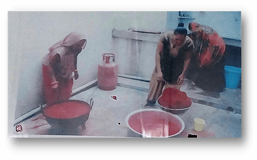 Photo showing weavers adding colours to the threads